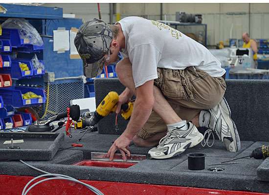 <p>Here, a Triton employee installs hardware such as hinges and box lids.</p> 