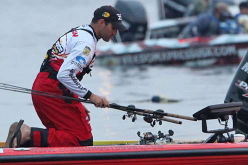 <p>Elite Series pro Casey Scanlon secures his rods to the boat deck.</p>
