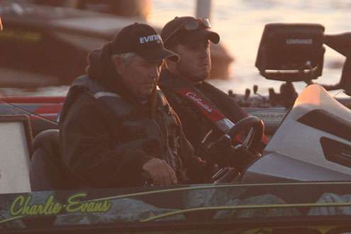 <p>Charlie Evans looks over instruments as he and his co angler line up in their flight order for Day Two.</p>

