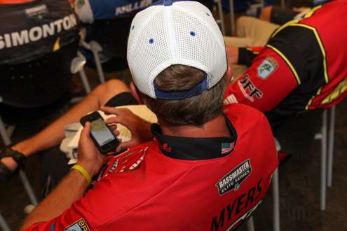 <p>Britt Myers looks over maps on his smartphone.</p>
