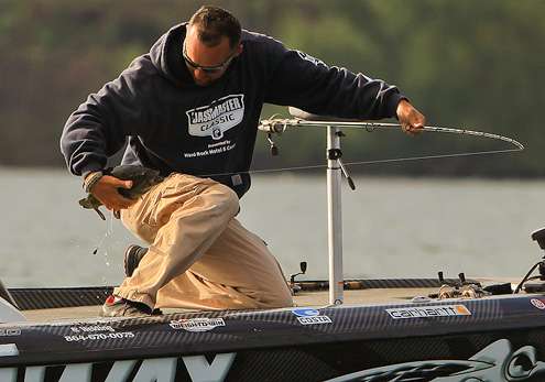 <p>Robinson secures the bass after swinging it aboard. </p>
