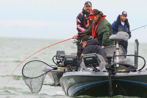 Co-angler Mark Babcock fights a fish in a crowd. 