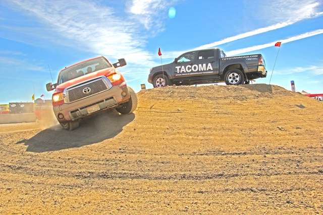 ...around a dirt pile topped by a Tacoma...