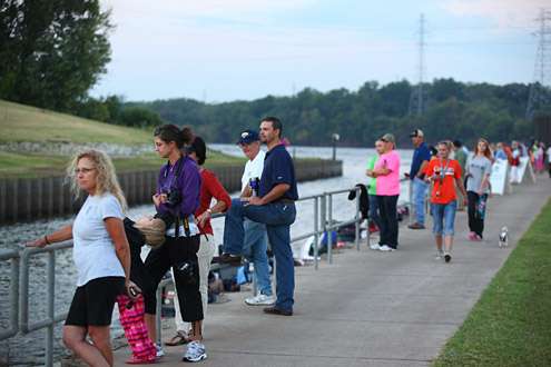 Fans line the railing of the Three Forks Harbor channel on Day One.