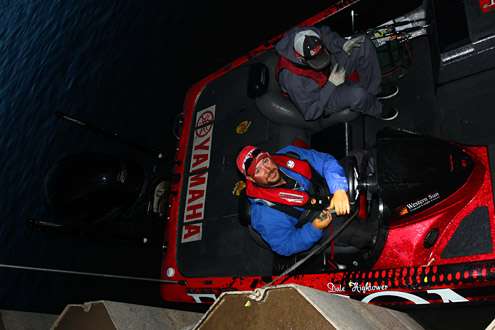 Dale Hightower ties a strap to his steering wheel to keep his boat in position on the pier.