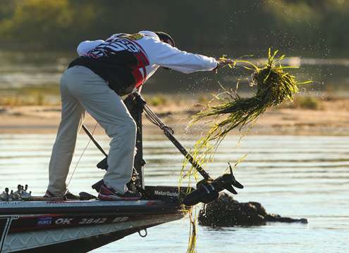 Evers removes grass from his trolling motor before making another move.
