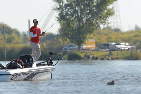 As he runs up the river he stops at floating logs to see if they hold any bass.