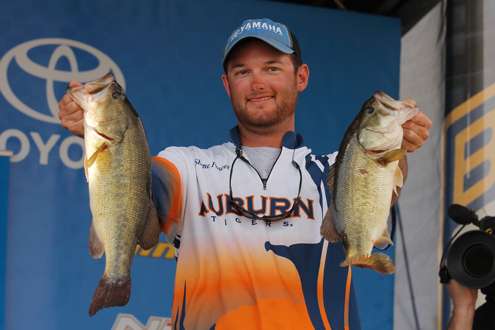 Shane Powell holds two of his nice fish on stage.