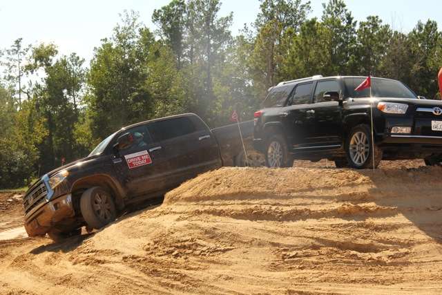 A 2014 Toyota Tundra circles a 4Runner at the fan-friendly Toyota Drive Center.