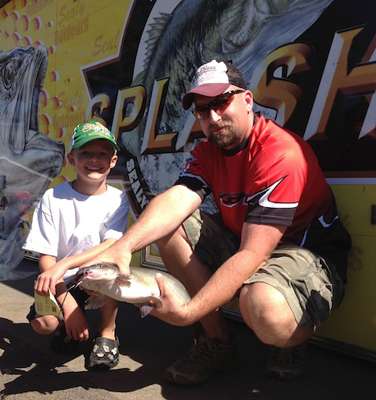 Carl Beall with Little Angler showing off his catch.