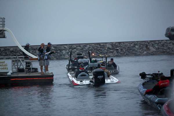 The boats file through the final safety check before heading out into the lake. 