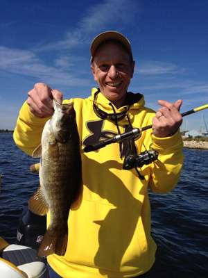 <p>Oswald holds up a nice Michigan bass caught on his day on the water with Skeet. Enter today for your chance to win our next contest â the <a href=