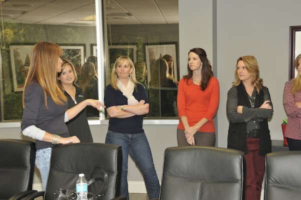 Lesley Martens, left, tells B.A.S.S. staffers about her impromptu trip to Detroit in August with her children so they could be there for Aaron when he won Angler of the Year.