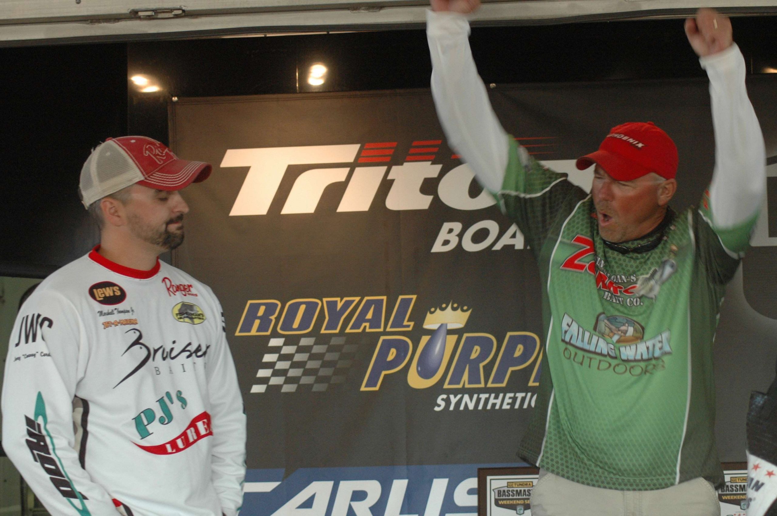 That angler is leader Adam Wagner who raises his arms in victory after his fish are weighed. Standing beside him is runner up Marshall Thompson. 