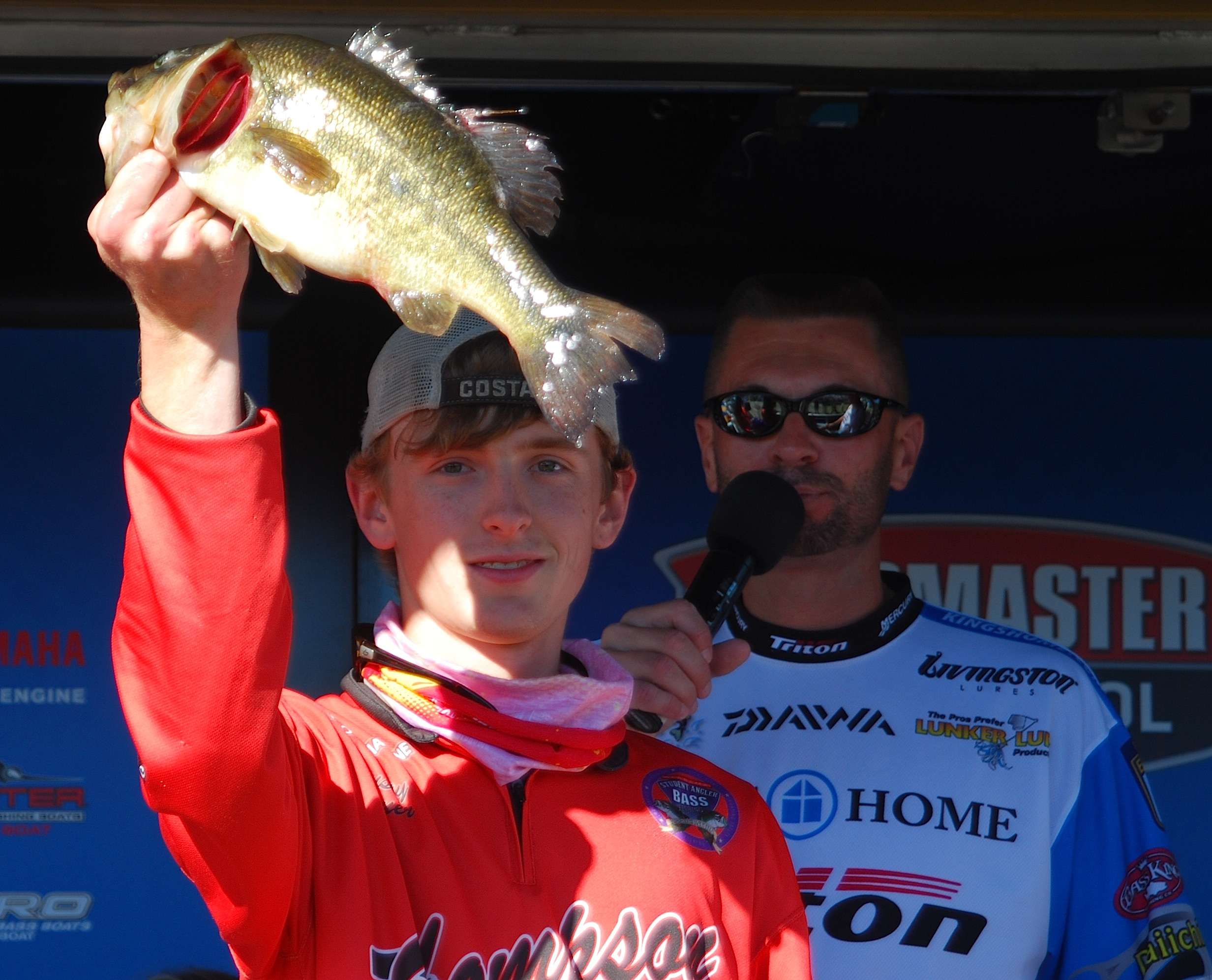 This angler from Thompson High holds his bass high. 