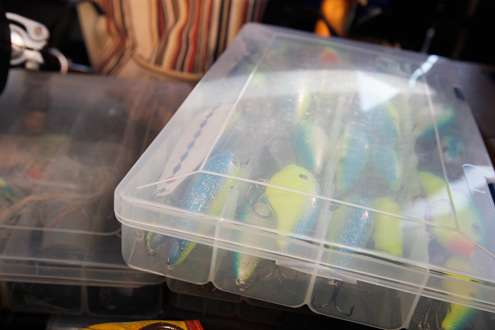 Most of his tackle is organized in plastic bins.