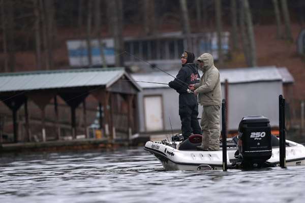 Shelton (left) and co-angler Richard Owen (right) fish near some boat docks early on Saturday.