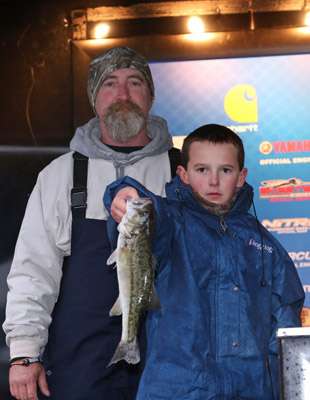 Colby Edwards holds up his fish with his grandfather, Stephen Evans.