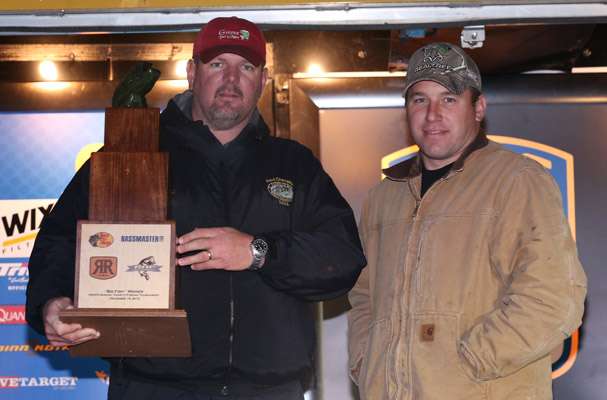 NASCAR driver Ryan Newman presents Big Fish winner Jody Wright (left) with his trophy.