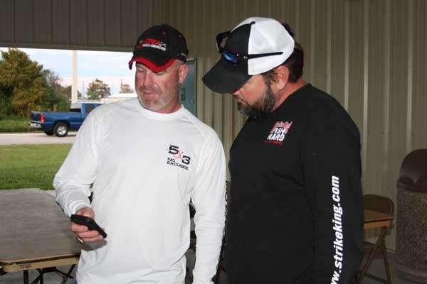 <p>The 60-pound mark was popular, too. That's what Elite pro Greg Hackney said when asked how much it would take to win on Okeechobee this week. If he can win, he'll qualify for his 12th straight Classic. Here, newly-announced Elite pro Chad Morgenthaler and Hackney check on their boat numbers for Thursday's launch. Morgenthaler's prediction was 68 pounds.</p>
