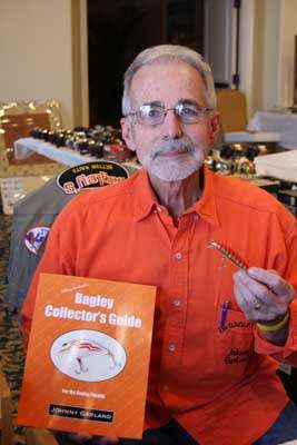 <p>Speaking of Bagley baits (which we were just a few slides back), Johnny Garland of Johnson City, Tenn., wrote the book on them ... quite literally. Garland knew Jim Bagley personally and made the cover of his <em>Bagley's Collectors Guide</em> (whitefishpress.com) orange because it was Bagley's favorite color. He's seen here with one of Jim's most famous designs, the Bang-O-Lure. This one is from the 1980s, when Jim still owned the company, and is worth $20-25. Garland likes American-made baits for his collections, saying that good finishes on baits are timeless and help them maintain their value.</p>
