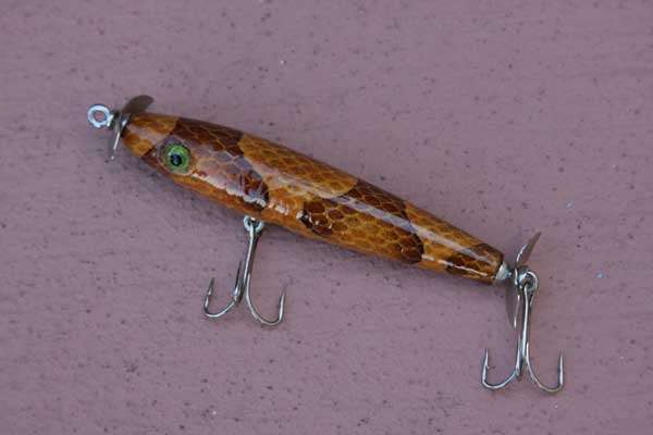 <p>Morgan's notoriety in the collecting field is due largely to his work with snake and frog skins. His lures have finishes like nothing you've ever seen before because each is unique. This is his Snakeskin Torpedo with a copperhead skin finish. The skin once clothed an actual poisonous snake!</p>
