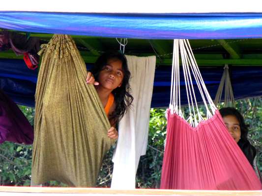 <p>Children of the camp staff relax in hammocks. </p>
