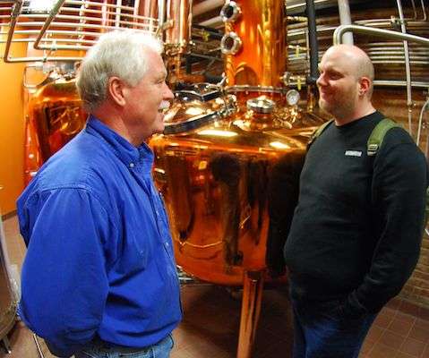 B.A.S.S. staffer Chris Mitchell (right) learns about the process of making bourbon from Artisanal Craft Distiller Charlie Downs. 