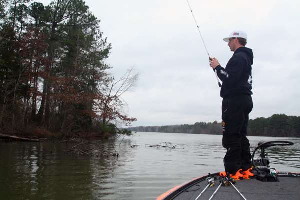 11:35 a.m. Still trying to connect with a lunker bass, Shryock probes wood cover on a main-lake point with a jig.