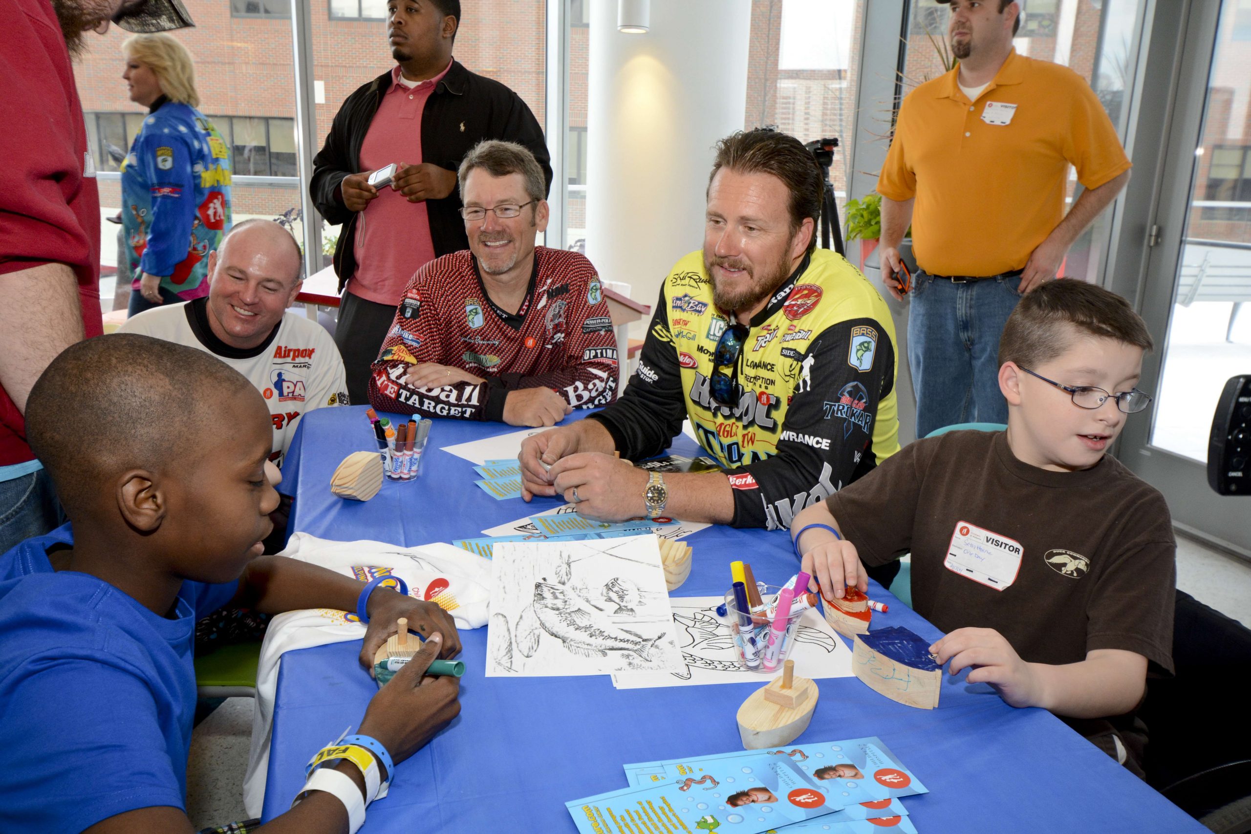 Skeet Reese, Coby Carden and Stephen Browning join two children at their craft table.