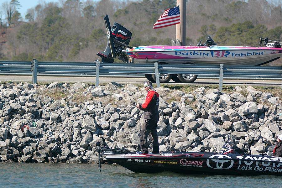 Gerald Swindle is another pro that keyed on riprap. A bass boat on a trailer flies by on a busy highway overhead.