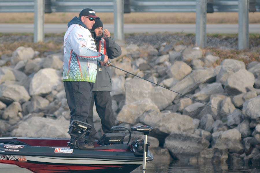 Coby Carden started the second day in 6th place. His first stop was where he caught his biggest bass the first day. His cameraman adjusts his microphone. Carden is so pumped he doesnât even know the guy is there.