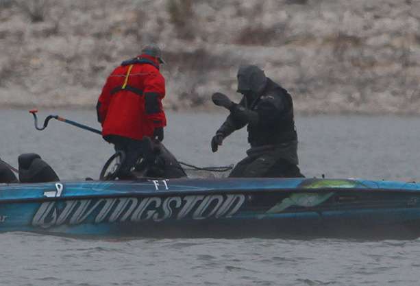 Velvick struggles with cold hands to land a fish. 