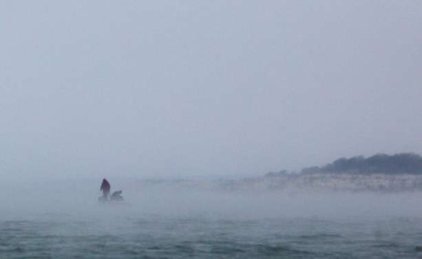 A competitor shrouded in a very cold and wet fog. 
