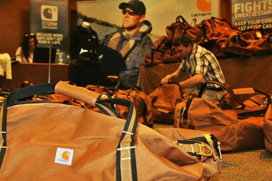 A Carhartt worker prepares duffel bags filled with clothing for the 55 anglers who will compete in the 2014 GEICO Bassmaster Classic present by Diet Mountain Dew and GoPro. 