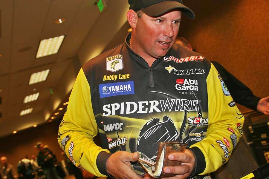 Bobby Lane puts his license back in his wallet after proving he was legal to fish the Classic.