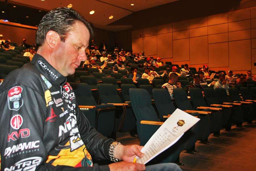 From the front row, Kevin VanDam peruses the information sheets given to the anglers.