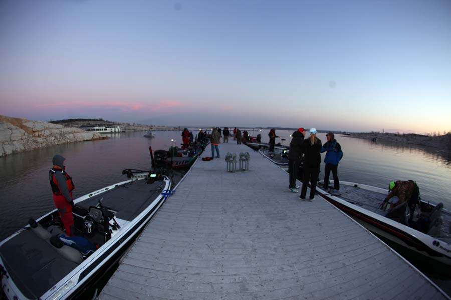The sun begins to rise over the lake as the anglers are set to go out.