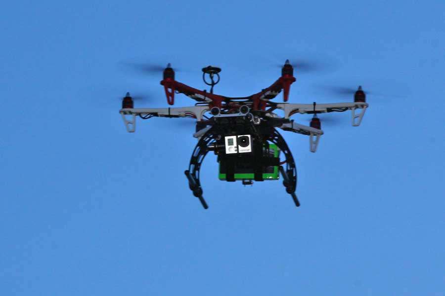 A remote control helicopter equipped with GoPro cameras captures the scene.
