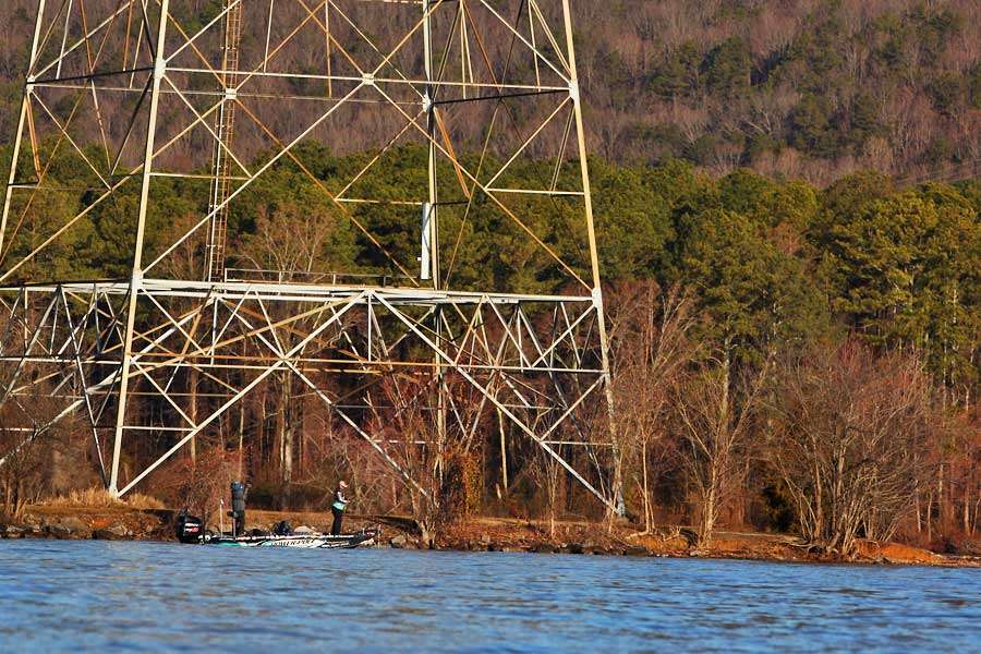 Chris Lane fishes under an electric tower. The next 15 images show a catch.