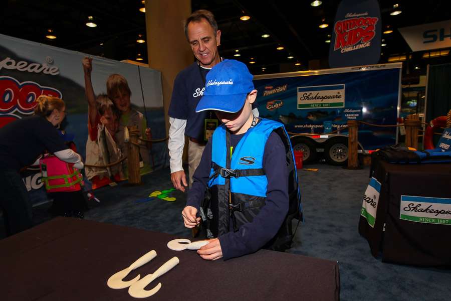 Branden age 9 from Oklahoma is rigging a bait in the Shakespeare booth this moring.  This is his 3 Bassmaster Classic.
