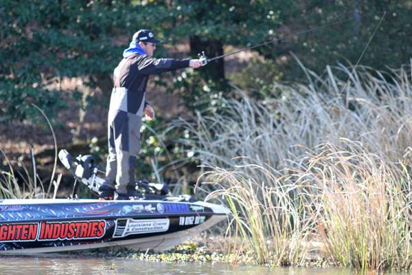 Grant Goldbeck drops his bait into the shallow grass looking for bedding fish.

