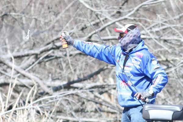 Again, he sprays his lure with attractant.