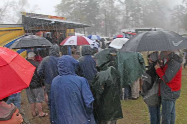 Many of them huddled under umbrellas during the downpour.