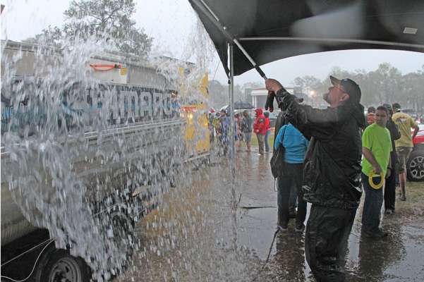 Behind the stage, Max Leatherwood did everything possible to keep water from weighing down the holding tent.