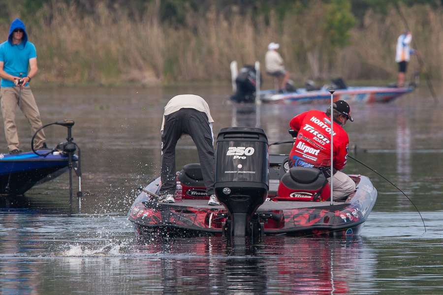 Horton has a fish on and fish are jumping all around him.  Miller looks on in his Yamaha wrapped Skeeter.