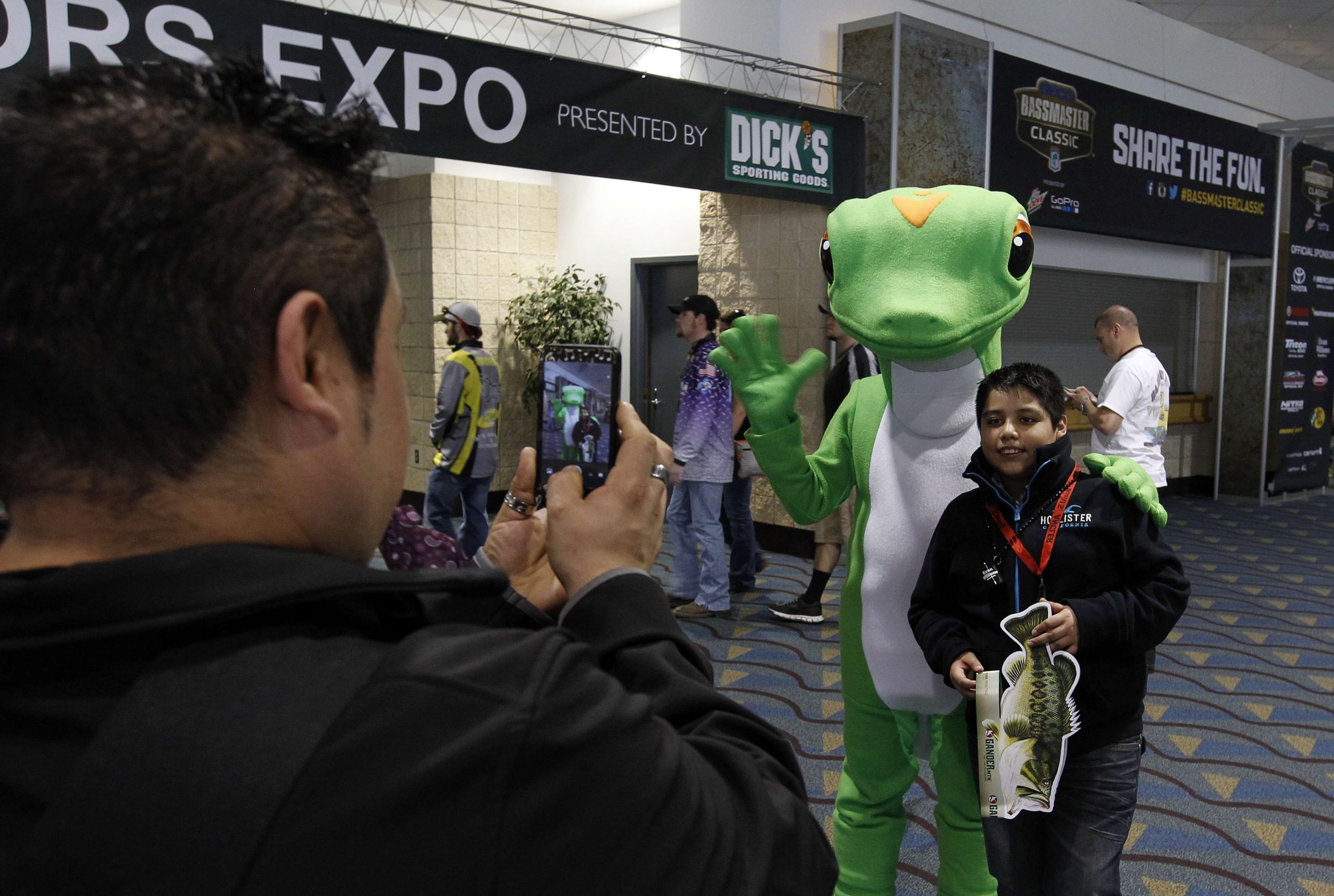 Just like a famous angler, the GEICO Gecko couldn't get too far without getting some pictures with fans.