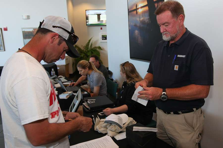 Mike Iaconelli checks in and produces his fishing license.