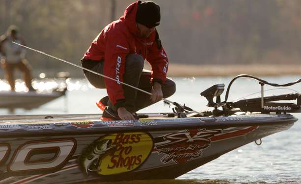 Jason Williamson selects his weapon from the deck of his boat. 