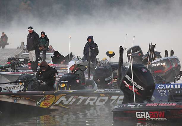 The Elite anglers play the waiting game as the fog hangs around early this morning.